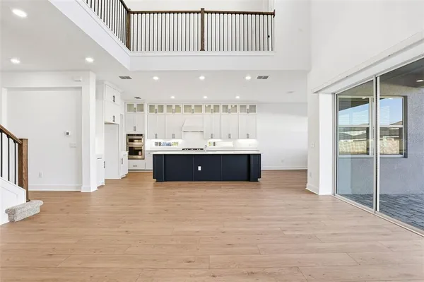 a view of kitchen with center island and wooden floor