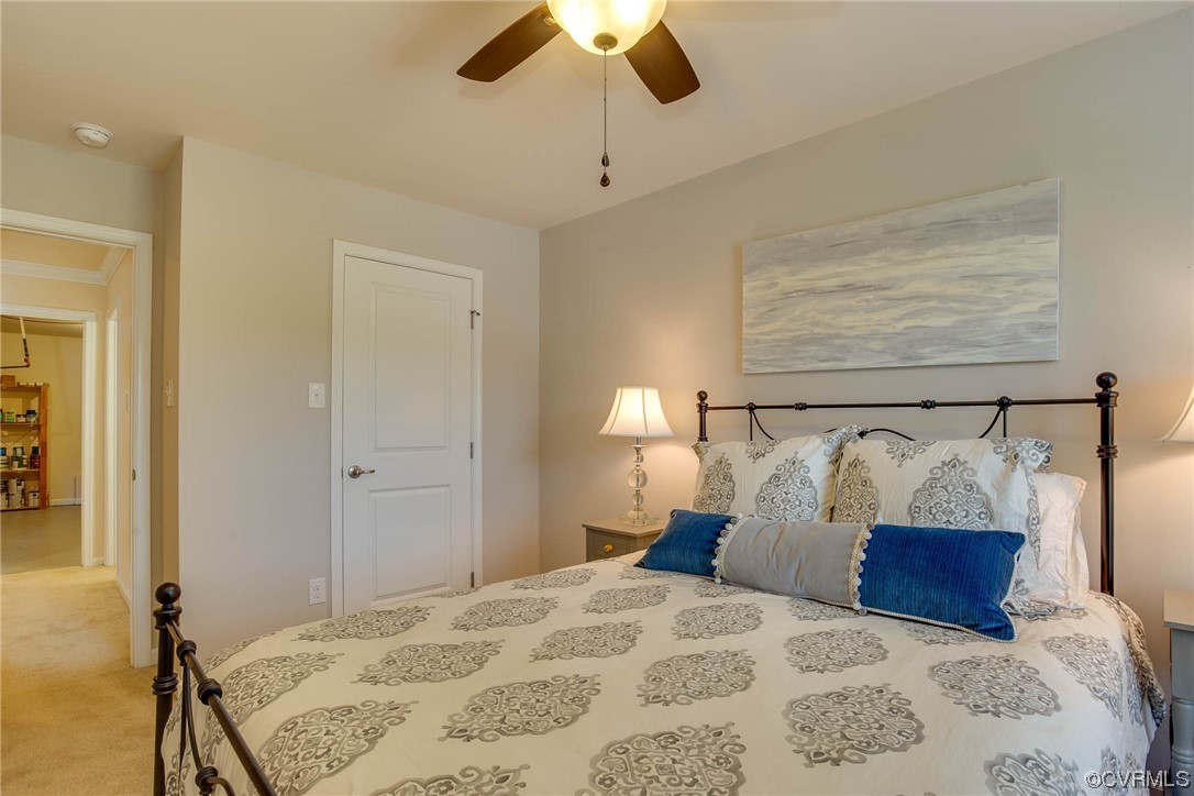 5841 Riverside Trail Richmond, VA 23225 - Photo 24 of 28 a bedroom with a bed and a chandelier