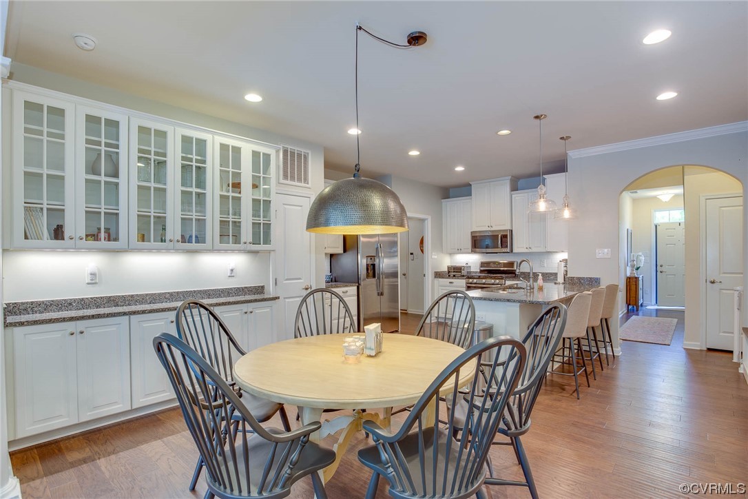 5841 Riverside Trail Richmond, VA 23225 - Photo 3 of 28 a kitchen with stainless steel appliances granite countertop a kitchen island a table and chairs in it