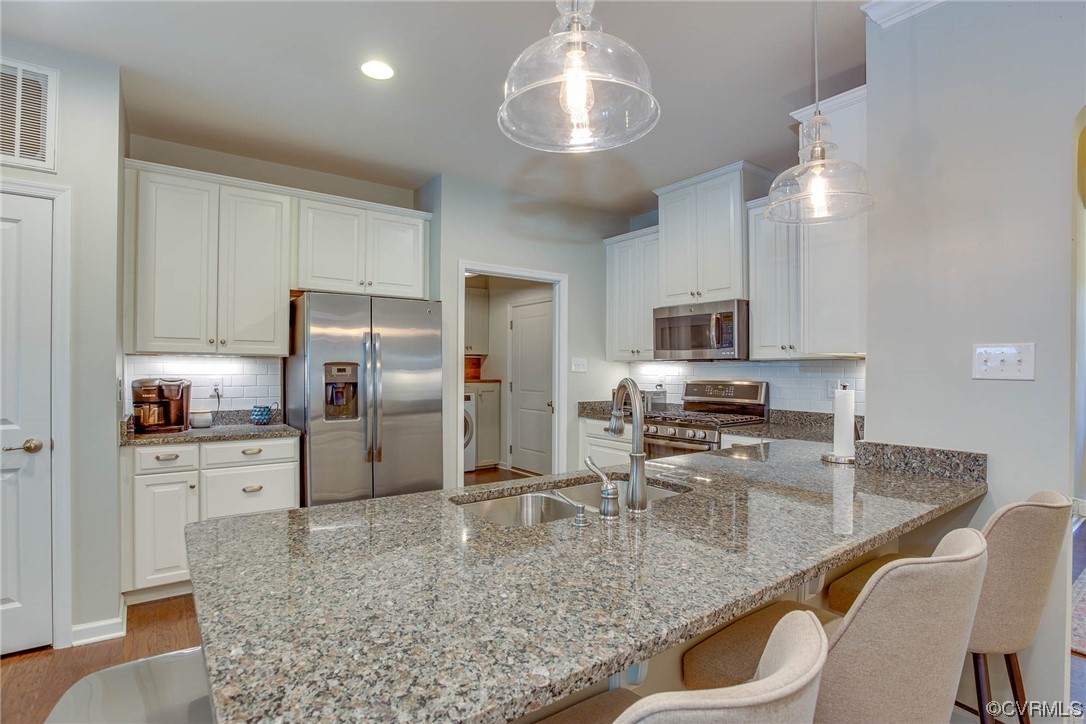 5841 Riverside Trail Richmond, VA 23225 - Photo 4 of 28 a kitchen with stainless steel appliances granite countertop a sink refrigerator and microwave