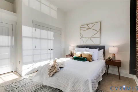 a living room with furniture and a floor to ceiling window