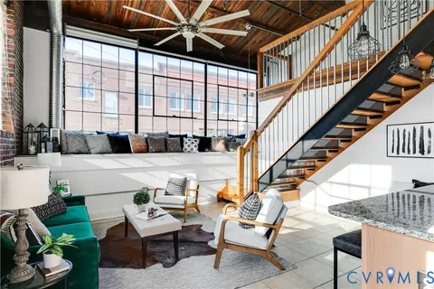 a bedroom with furniture and a large window