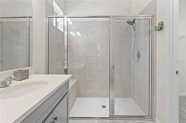 a bathroom with a shower and a sink
