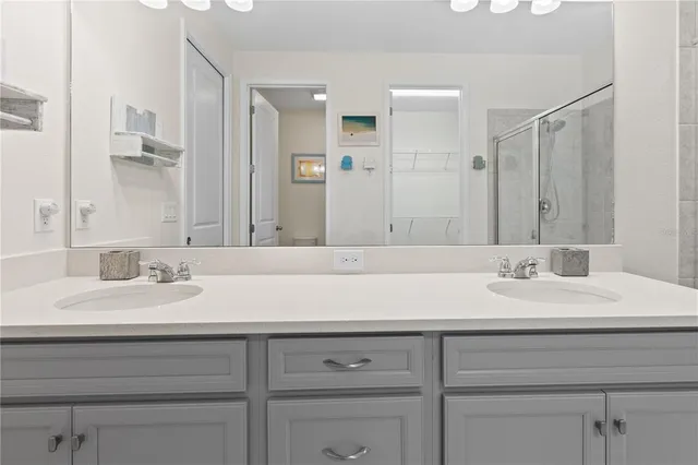 a bathroom with a sink vanity and a mirror