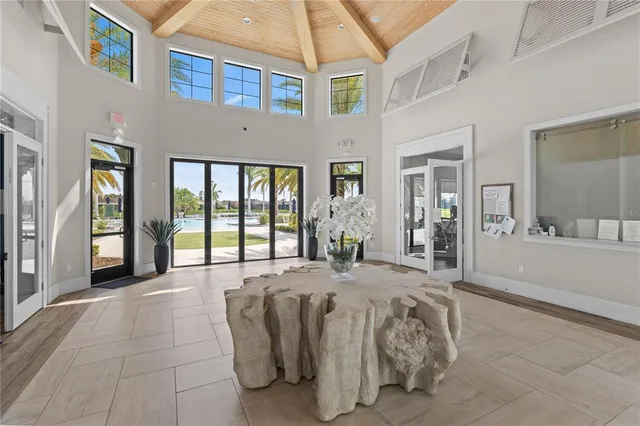 a spacious bedroom with a bed a table and painting on the wall
