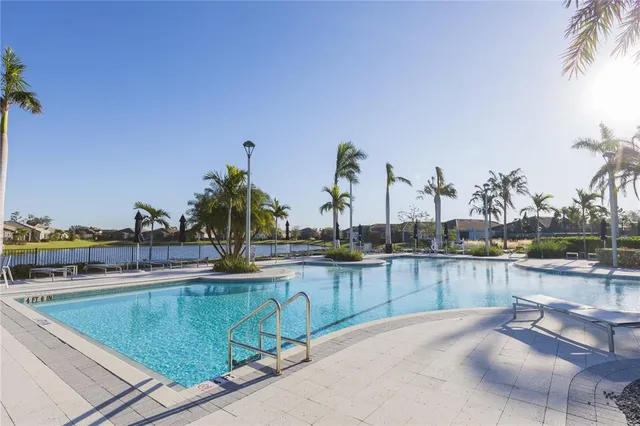 a view of a swimming pool with outdoor seating and lake