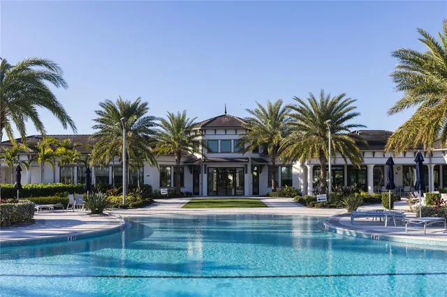 a view of swimming pool with palm trees