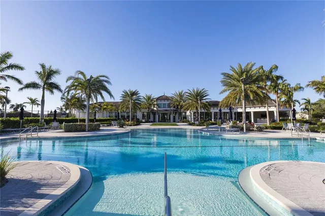 a swimming pool with outdoor seating and yard