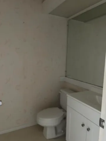 a white toilet sitting next to a shower
