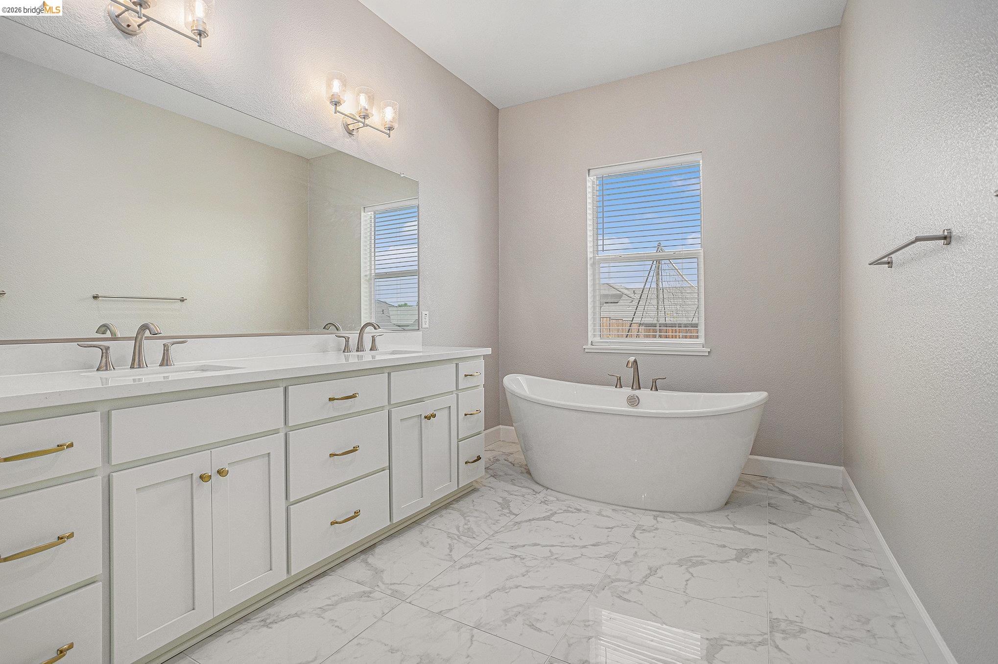 5010 Neroly Road Oakley, CA 94561 - Photo 21 of 40 a spacious bathroom with a double vanity sink a mirror and a bathtub