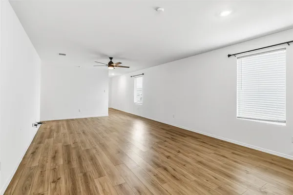 a view of a kitchen with a dishwasher and wooden floor