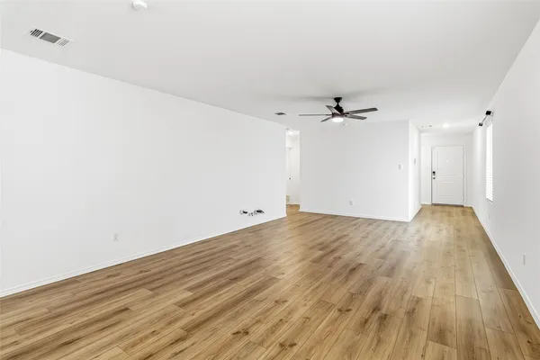 a view of kitchen with wooden floor and electronic appliances