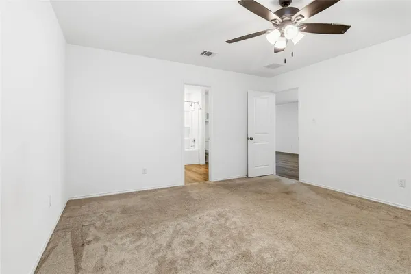 a bedroom with a bed a chandelier and a chandelier