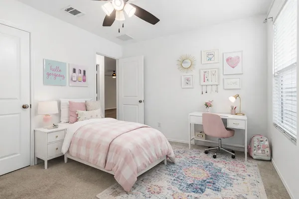 an empty room with chandelier fan