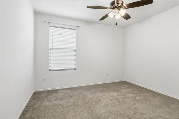 a bedroom with a bed and a chair