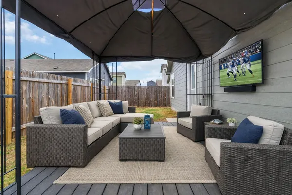 a outdoor living space with furniture and a flat screen tv