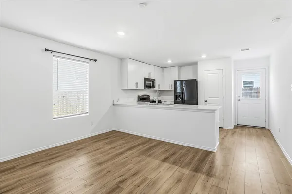 a view of a dining room with furniture and wooden floor