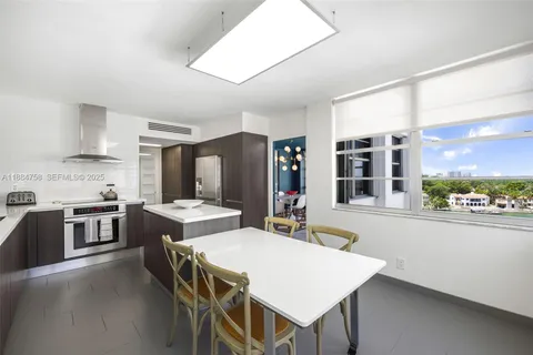 a large kitchen with a table and chairs in it