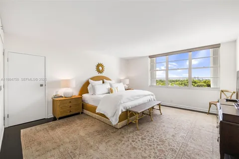 a bed room with a bed and a large window