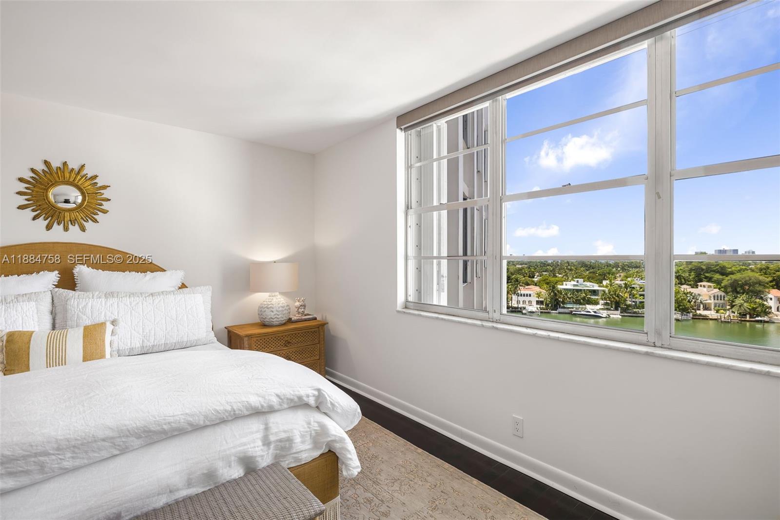 5660 Collins Avenue, Unit 8D Miami Beach, FL 33140 - Photo 17 of 41 a bedroom with a bed and a window