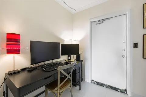a view of a workspace with furniture and a gate