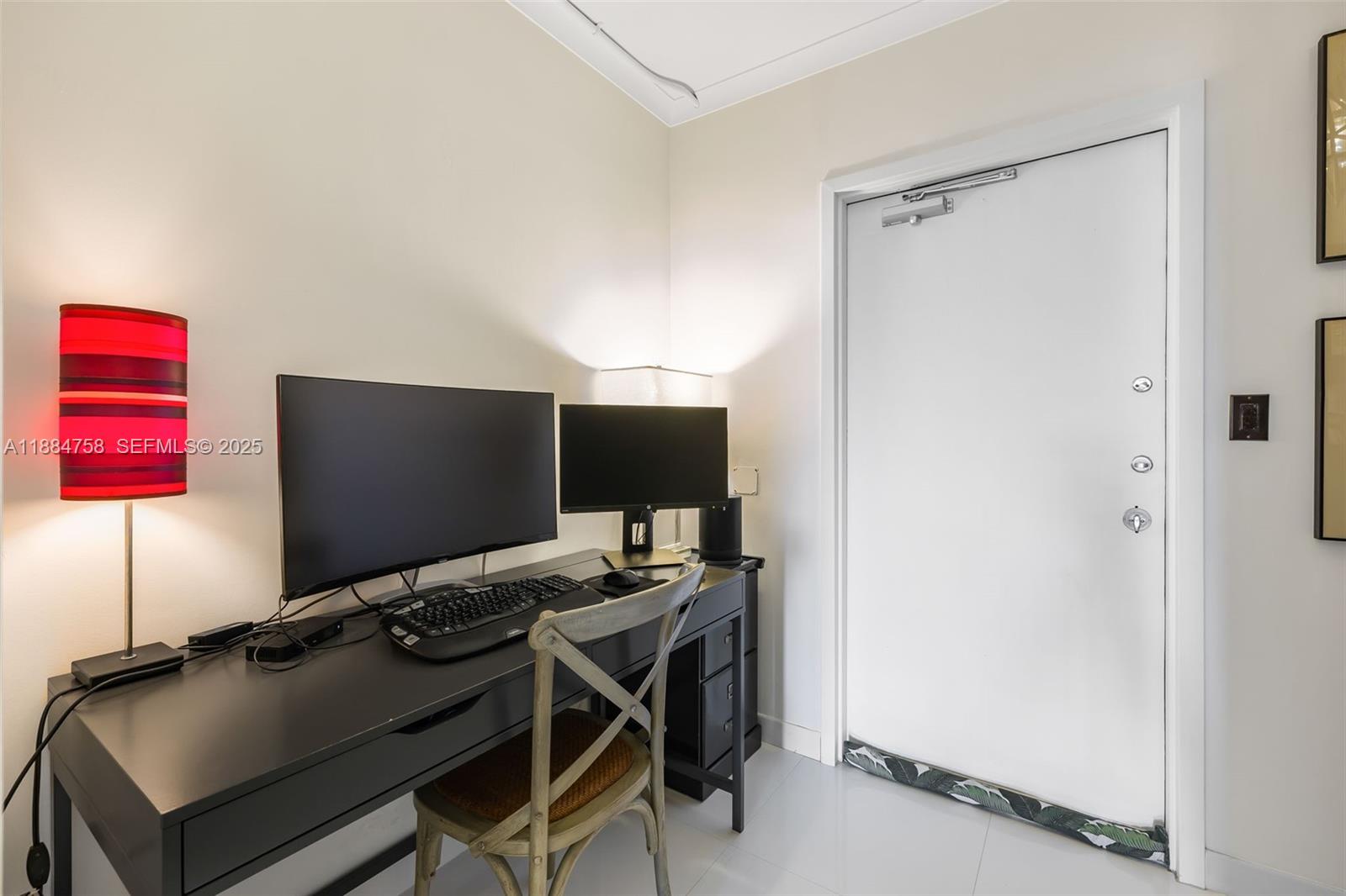 5660 Collins Avenue, Unit 8D Miami Beach, FL 33140 - Photo 23 of 41 a view of a workspace with furniture and a gate