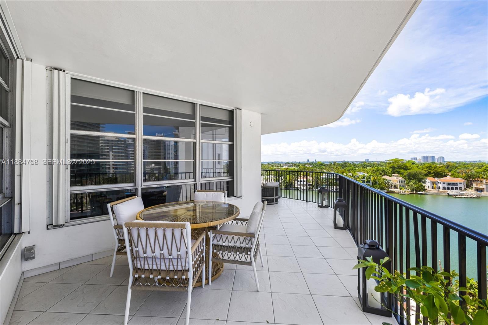 5660 Collins Avenue, Unit 8D Miami Beach, FL 33140 - Photo 29 of 41 a view of a chairs and table in the balcony