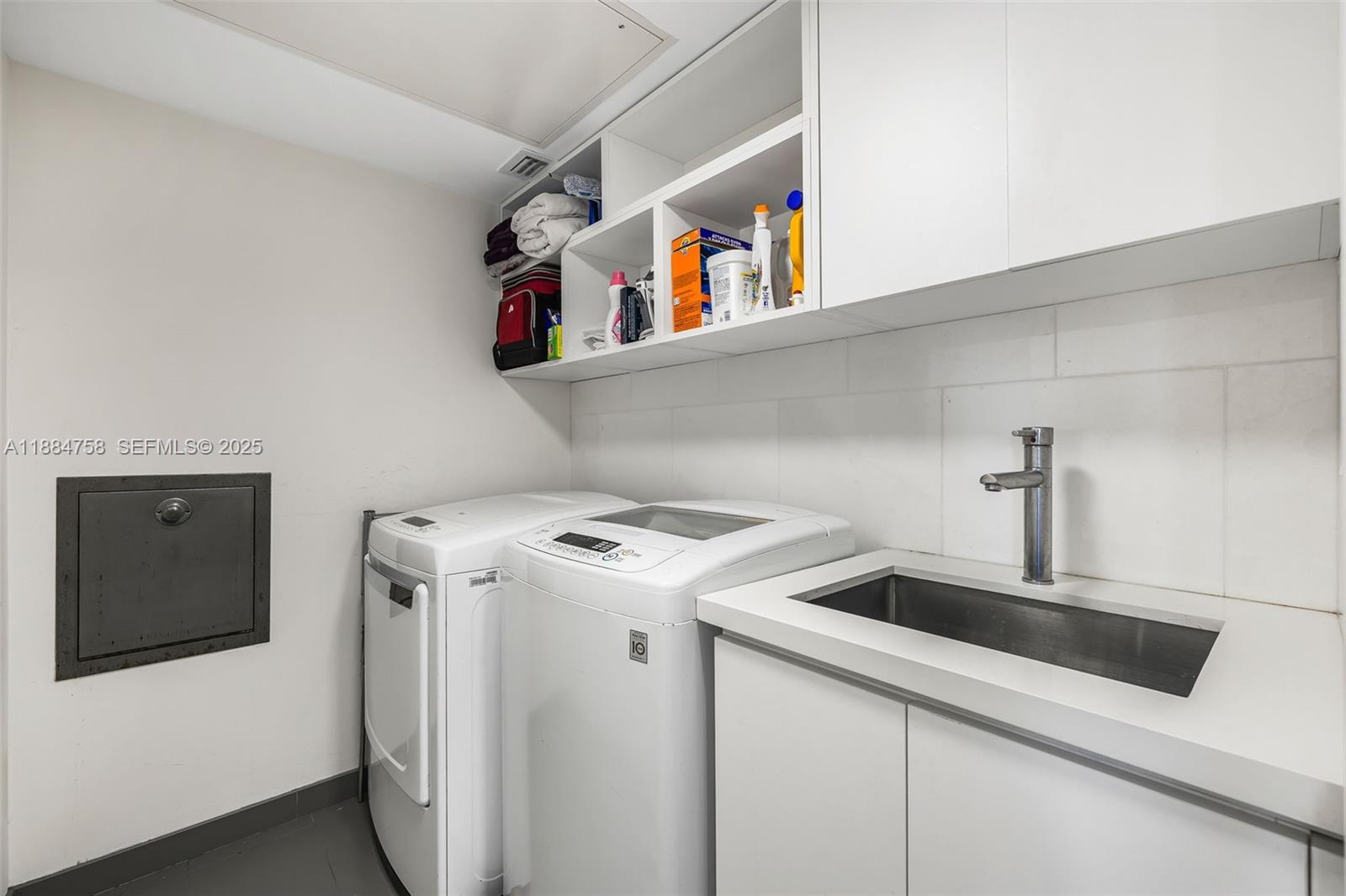 5660 Collins Avenue, Unit 8D Miami Beach, FL 33140 - Photo 33 of 41 a utility room with dryer and washer