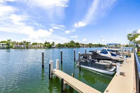 a view of a lake with couches in the patio