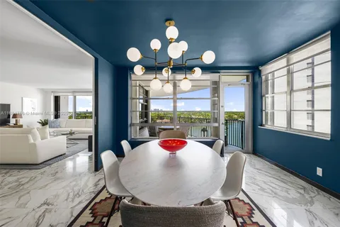 a view of a dining room with furniture wooden floor and chandelier