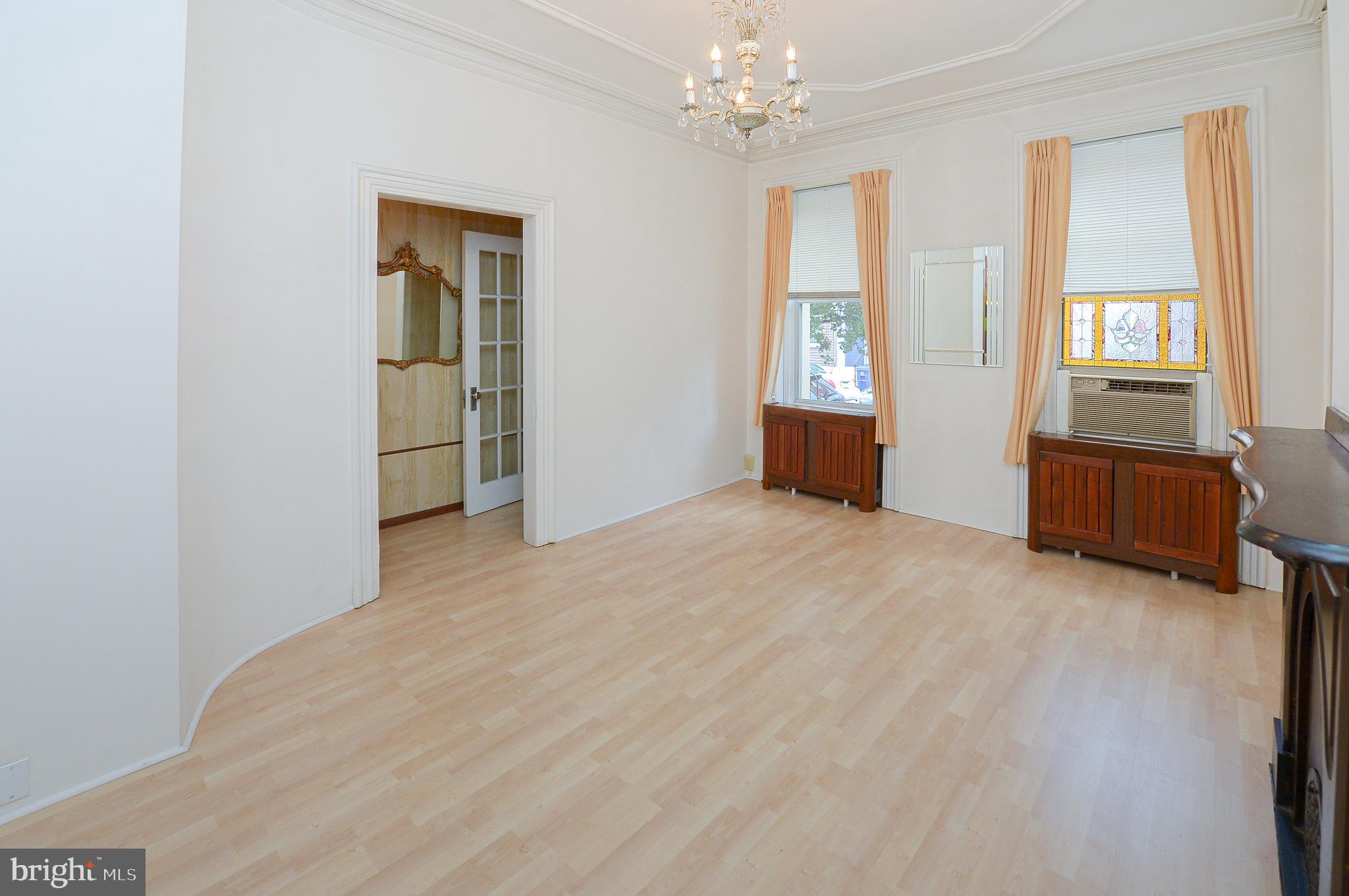 wooden floor chandelier and windows in a room