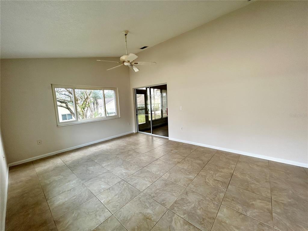 1907 Northwest 50th Circle Ocala, FL 34482 - Photo 6 of 25 an empty room with windows and ceiling fan view
