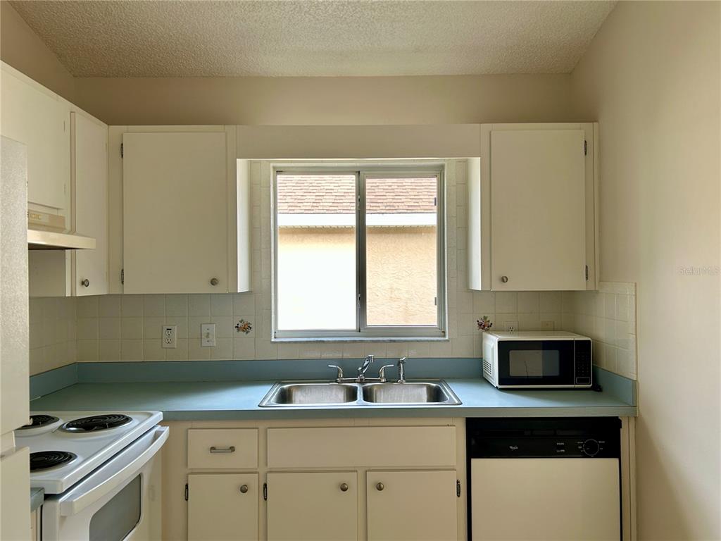 1907 Northwest 50th Circle Ocala, FL 34482 - Photo 8 of 25 a kitchen with a sink a stove and cabinets
