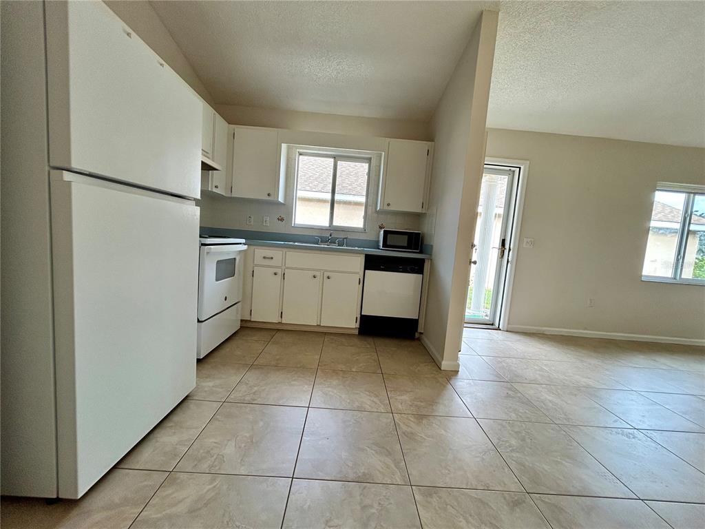 1907 Northwest 50th Circle Ocala, FL 34482 - Photo 10 of 25 a kitchen with granite countertop a stove top oven and sink