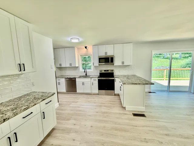 a view of a kitchen with wooden floor