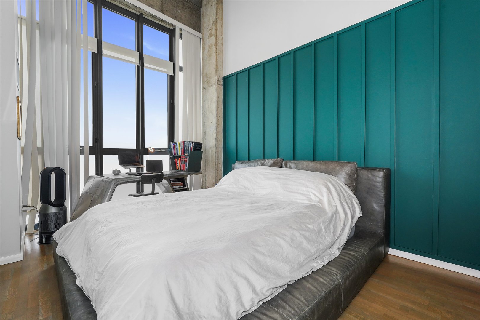 321 South Sangamon Street, Unit 902 Chicago, IL 60607 - Photo 11 of 18 a bed sitting in a spacious bedroom next to a window and dresser