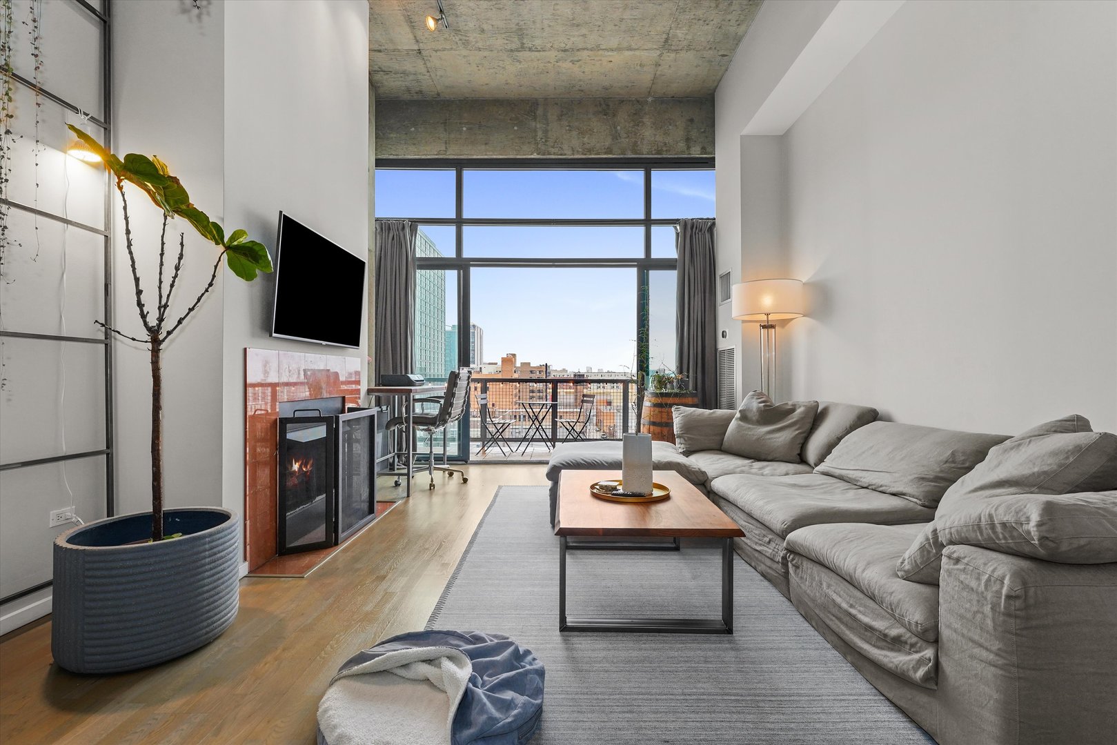 321 South Sangamon Street, Unit 902 Chicago, IL 60607 - Photo 2 of 18 a living room with furniture and a flat screen tv
