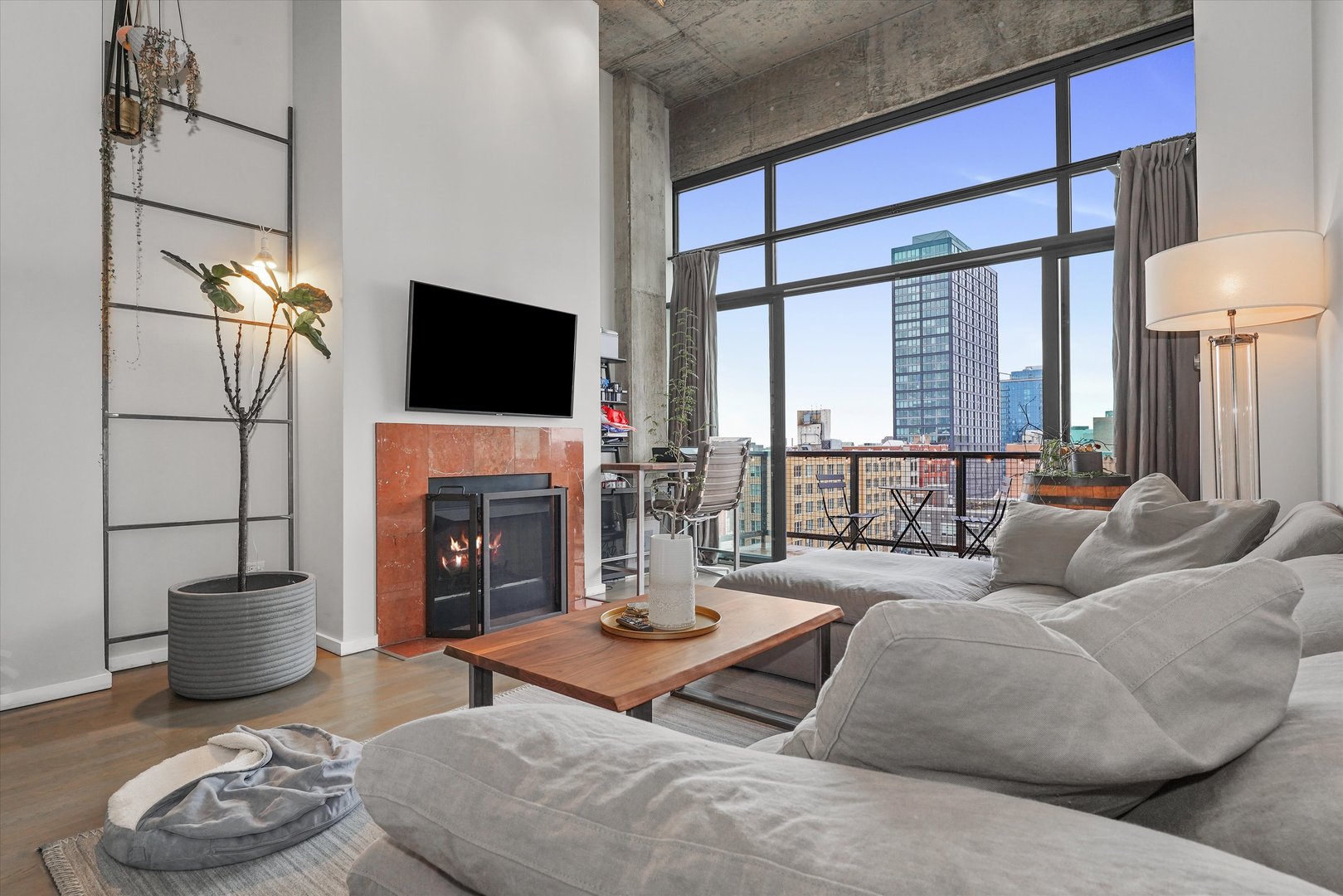 321 South Sangamon Street, Unit 902 Chicago, IL 60607 - Photo 4 of 18 a living room with furniture a fireplace and a flat screen tv