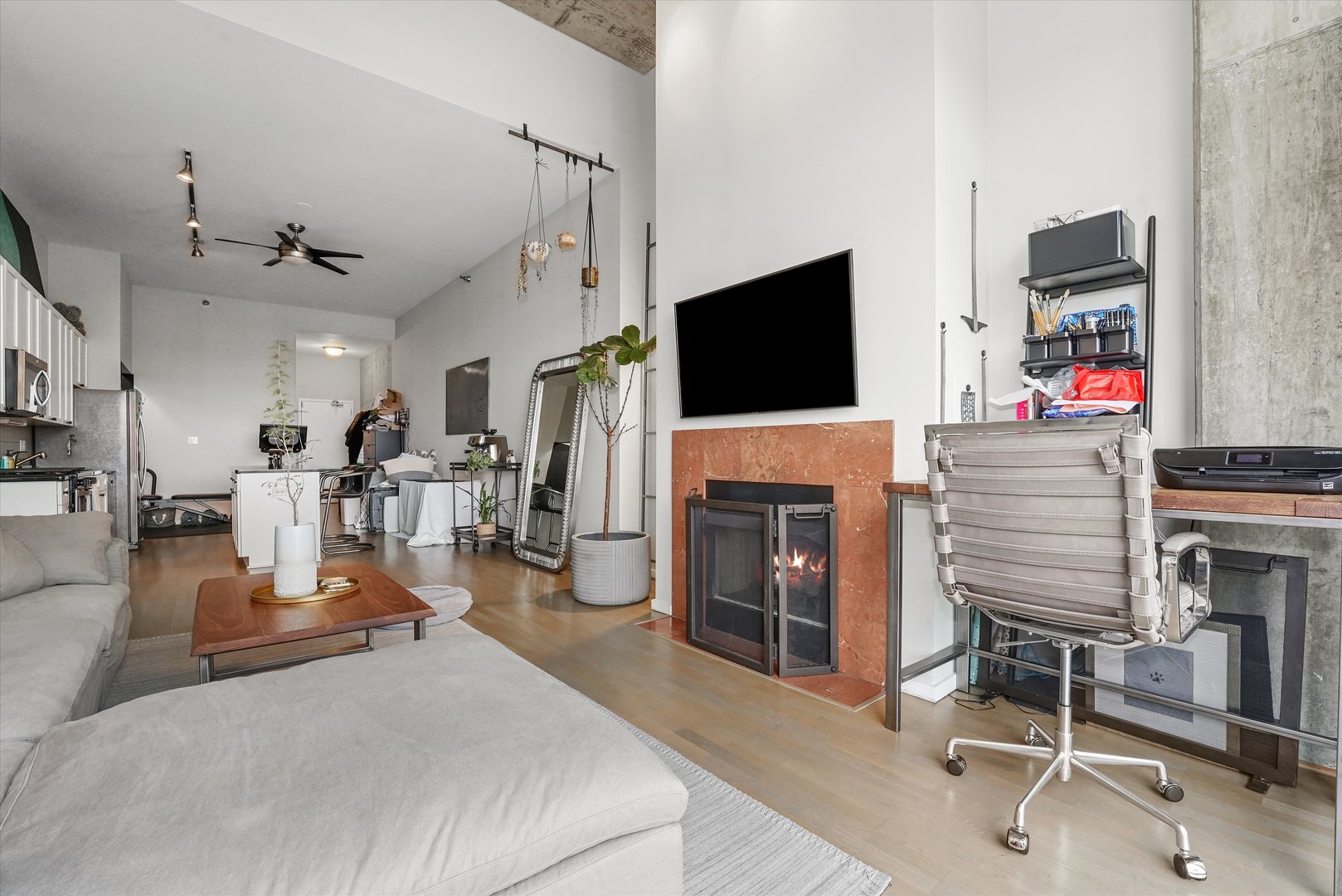 321 South Sangamon Street, Unit 902 Chicago, IL 60607 - Photo 7 of 18 a living room with furniture a flat screen tv and a fireplace
