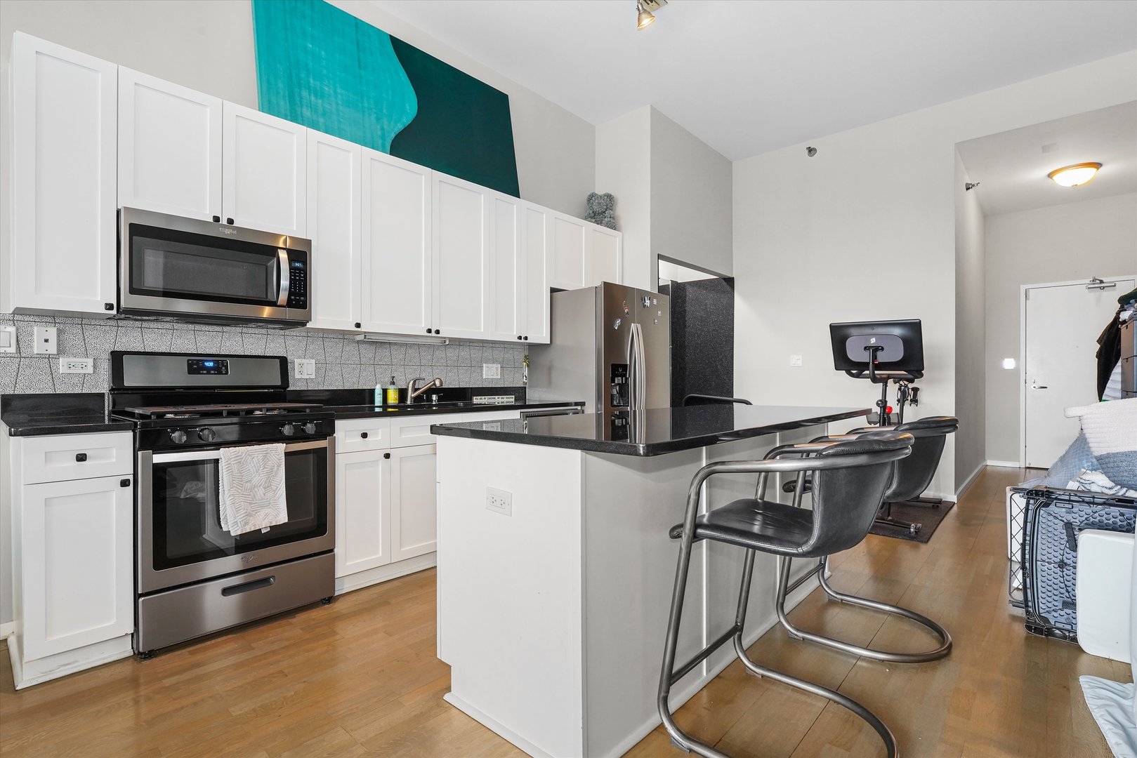 321 South Sangamon Street, Unit 902 Chicago, IL 60607 - Photo 8 of 18 a kitchen with stainless steel appliances a stove a sink a microwave a refrigerator and cabinets