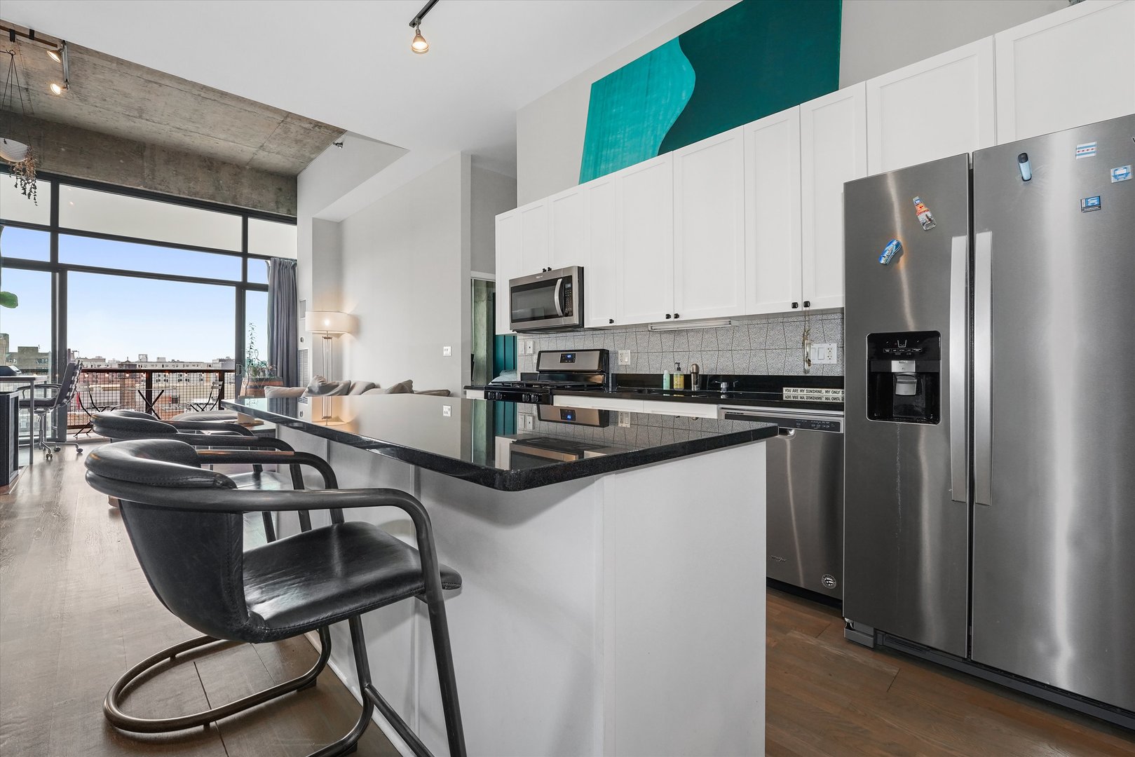 321 South Sangamon Street, Unit 902 Chicago, IL 60607 - Photo 9 of 18 a kitchen with stainless steel appliances a sink a stove a refrigerator and cabinets