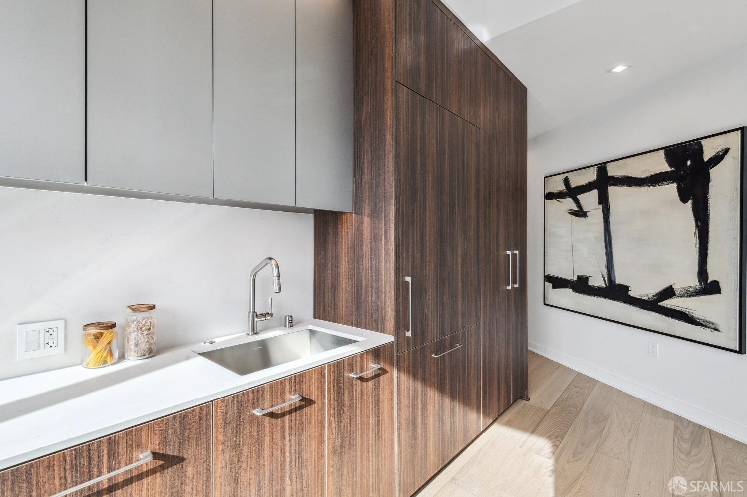 280 Spear Street, Unit 34C San Francisco, CA 94105 - Photo 15 of 47 a kitchen with stainless steel appliances a sink dishwasher a refrigerator and a stove with wooden floor