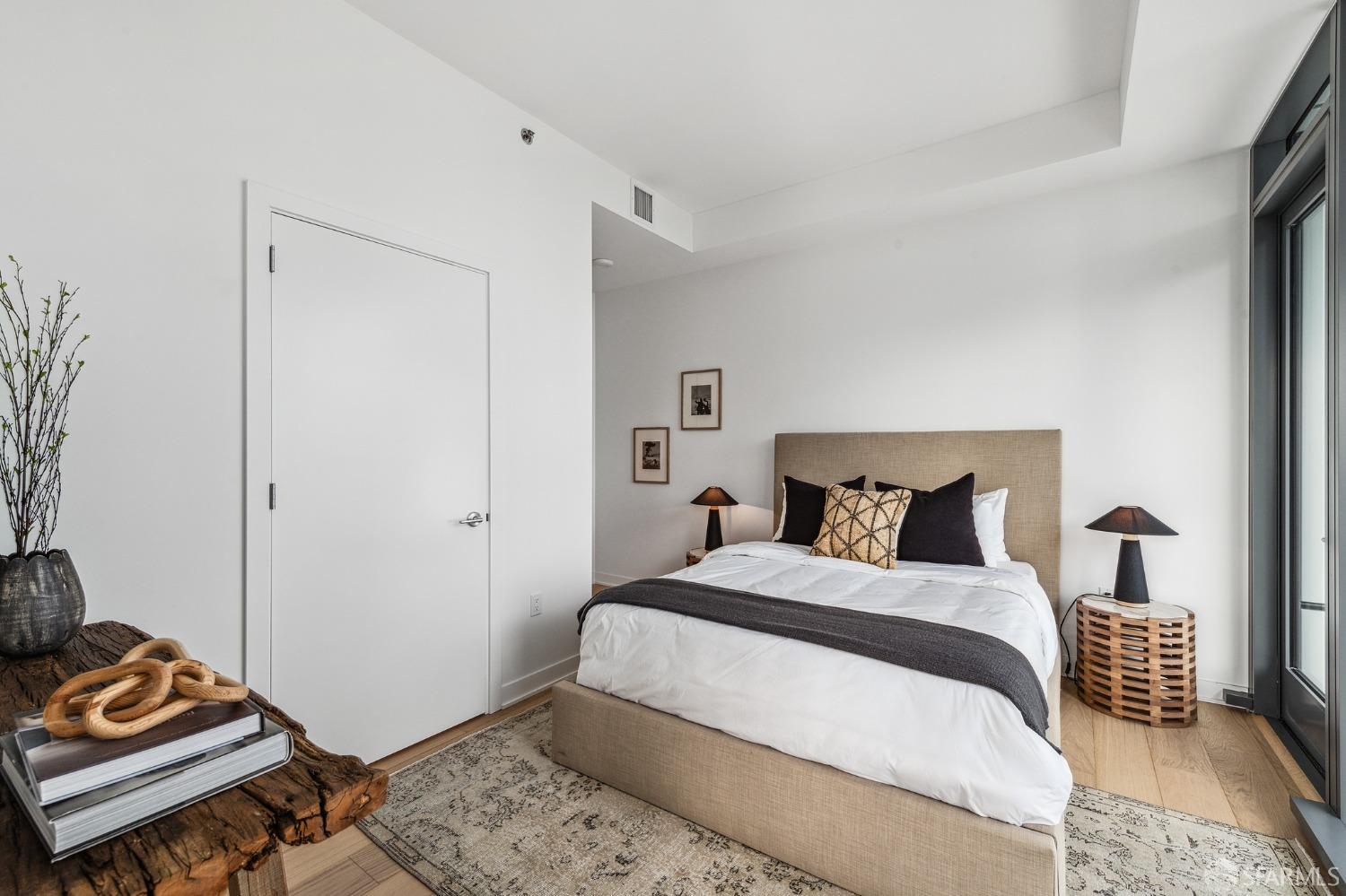 280 Spear Street, Unit 34C San Francisco, CA 94105 - Photo 22 of 47 a bedroom with a bed and wooden floor