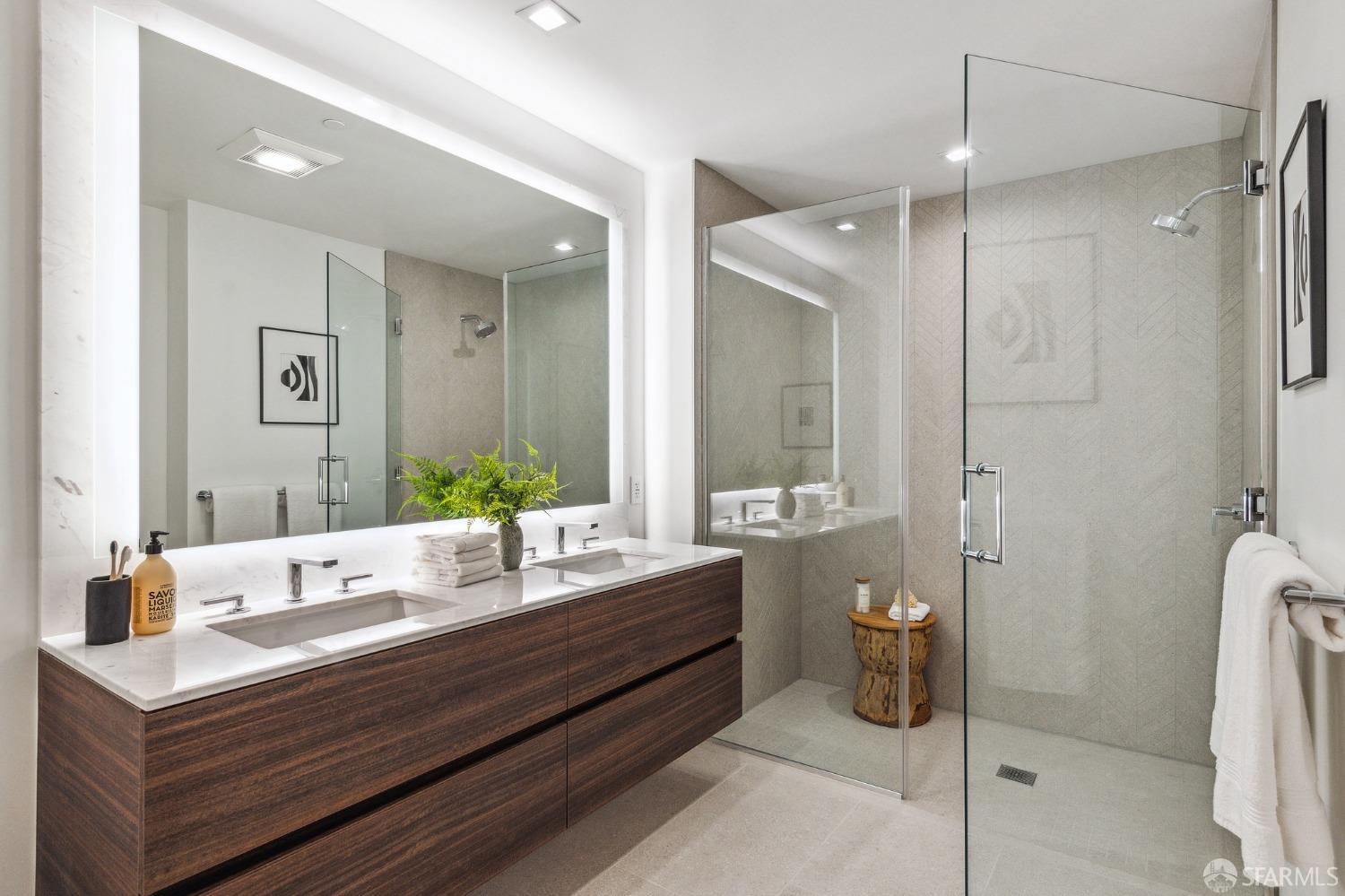 280 Spear Street, Unit 34C San Francisco, CA 94105 - Photo 27 of 47 a bathroom with a double vanity sink and mirror with shower
