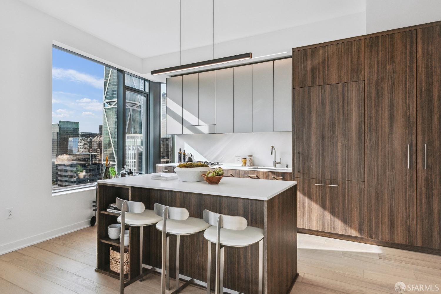 280 Spear Street, Unit 34C San Francisco, CA 94105 - Photo 10 of 47 a kitchen with a table chairs and a refrigerator