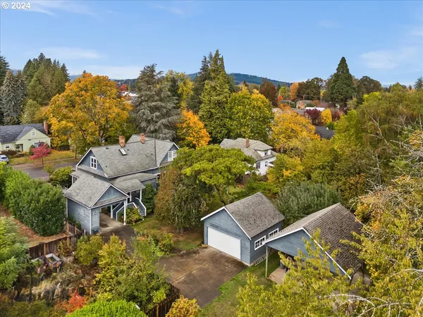 an aerial view of a house with a yard