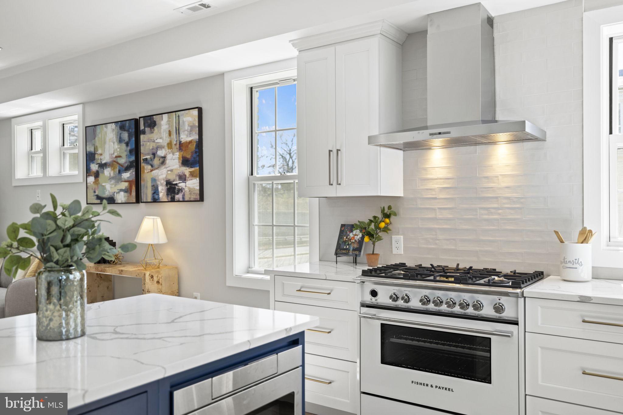 a kitchen with a stove and white cabinets