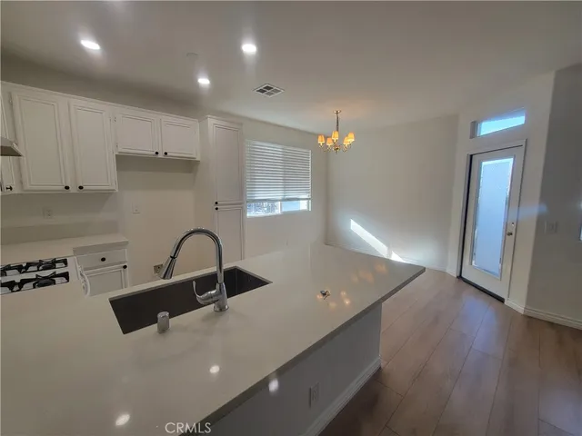 a kitchen with kitchen island sink stove and refrigerator