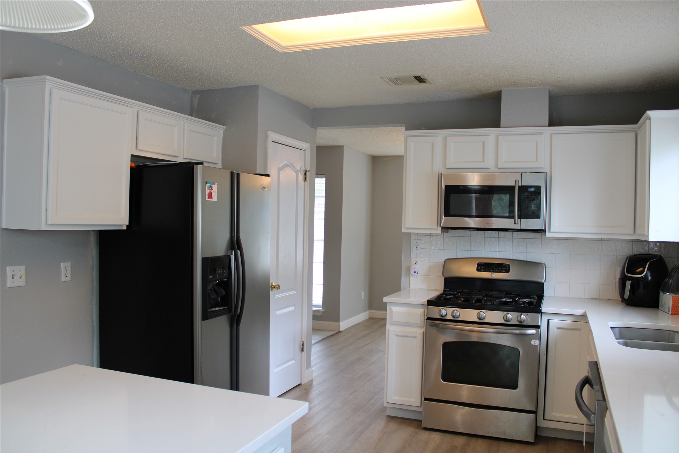 16205 Glorious Lane Pflugerville, TX 78660 - Photo 5 of 30 a kitchen with a refrigerator stove and microwave