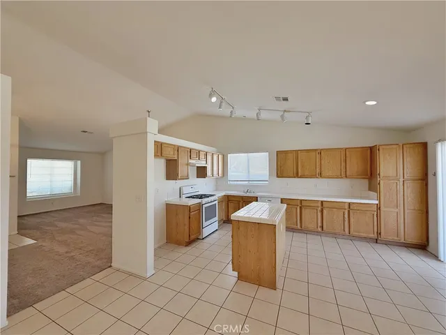 a large kitchen with cabinets and stainless steel appliances